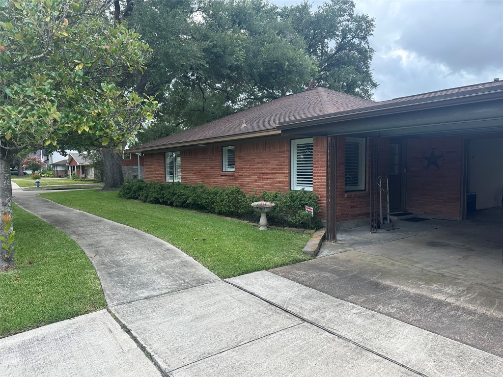 2123 Ridgecrest Drive Houston, TX 77055 - Photo 4 of 38 a front view of a house with a yard and trees