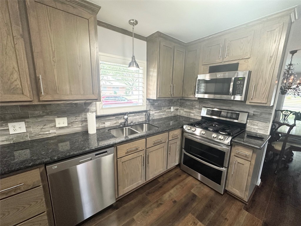 2123 Ridgecrest Drive Houston, TX 77055 - Photo 6 of 38 a kitchen with granite countertop a sink cabinets stainless steel appliances and a window