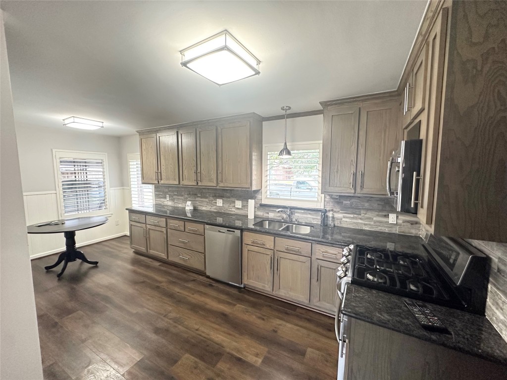 2123 Ridgecrest Drive Houston, TX 77055 - Photo 8 of 38 a kitchen with stainless steel appliances granite countertop a sink stove and cabinets