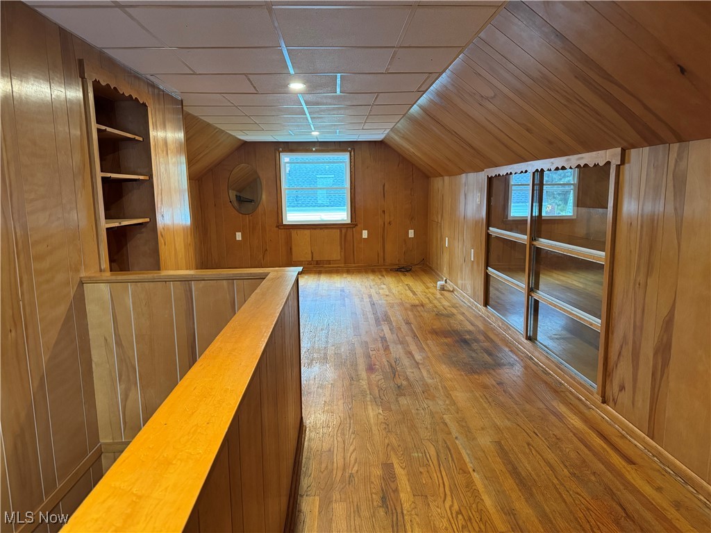 1139 Kessel Avenue Akron, OH 44310 - Photo 18 of 36 Bonus room with wood finished floors, wood walls, vaulted ceiling, and built in shelves