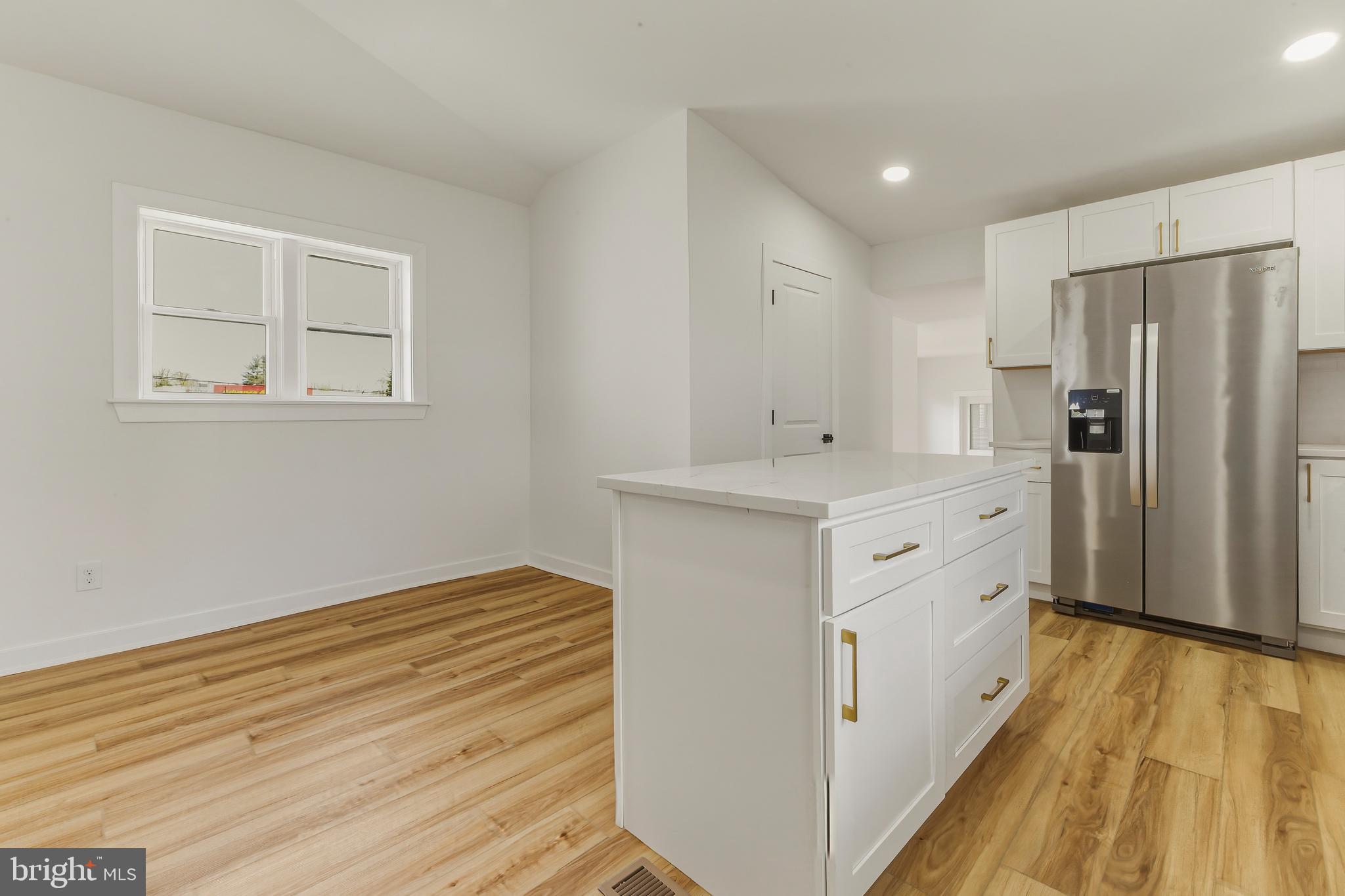 110 Washington Avenue Williamstown, NJ 08094 - Photo 11 of 32 a kitchen with stainless steel appliances cabinets and wooden floor