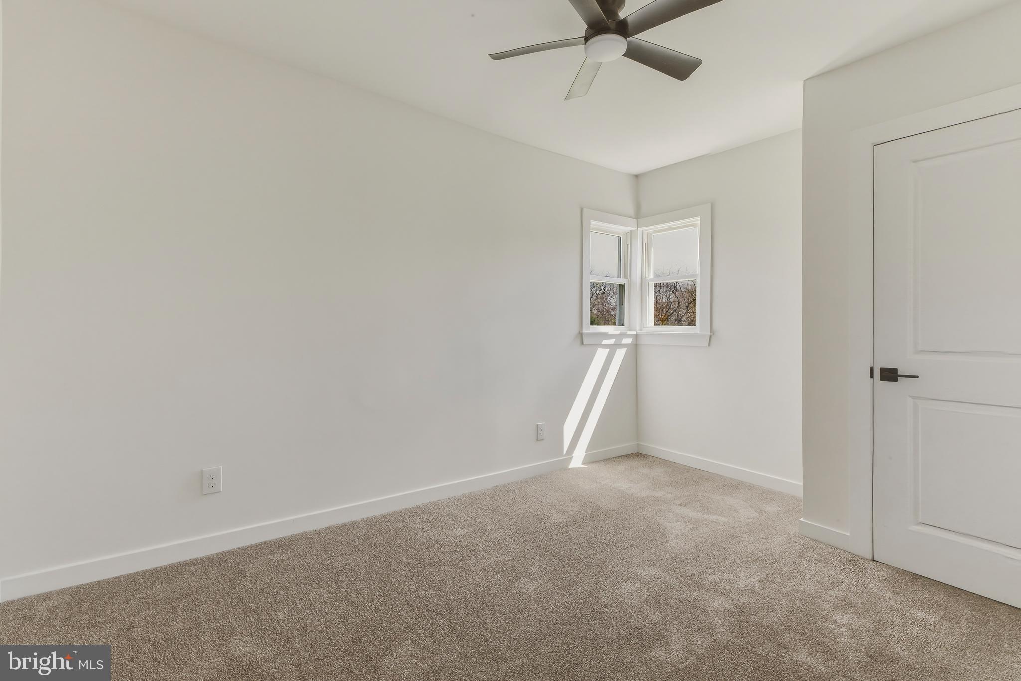 110 Washington Avenue Williamstown, NJ 08094 - Photo 23 of 32 an empty room with a ceiling fan and carpet