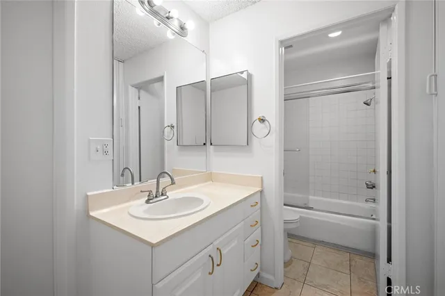 a bathroom with a sink shower and a mirror