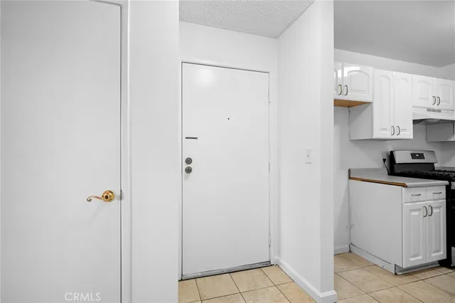 a kitchen with white cabinets and white appliances