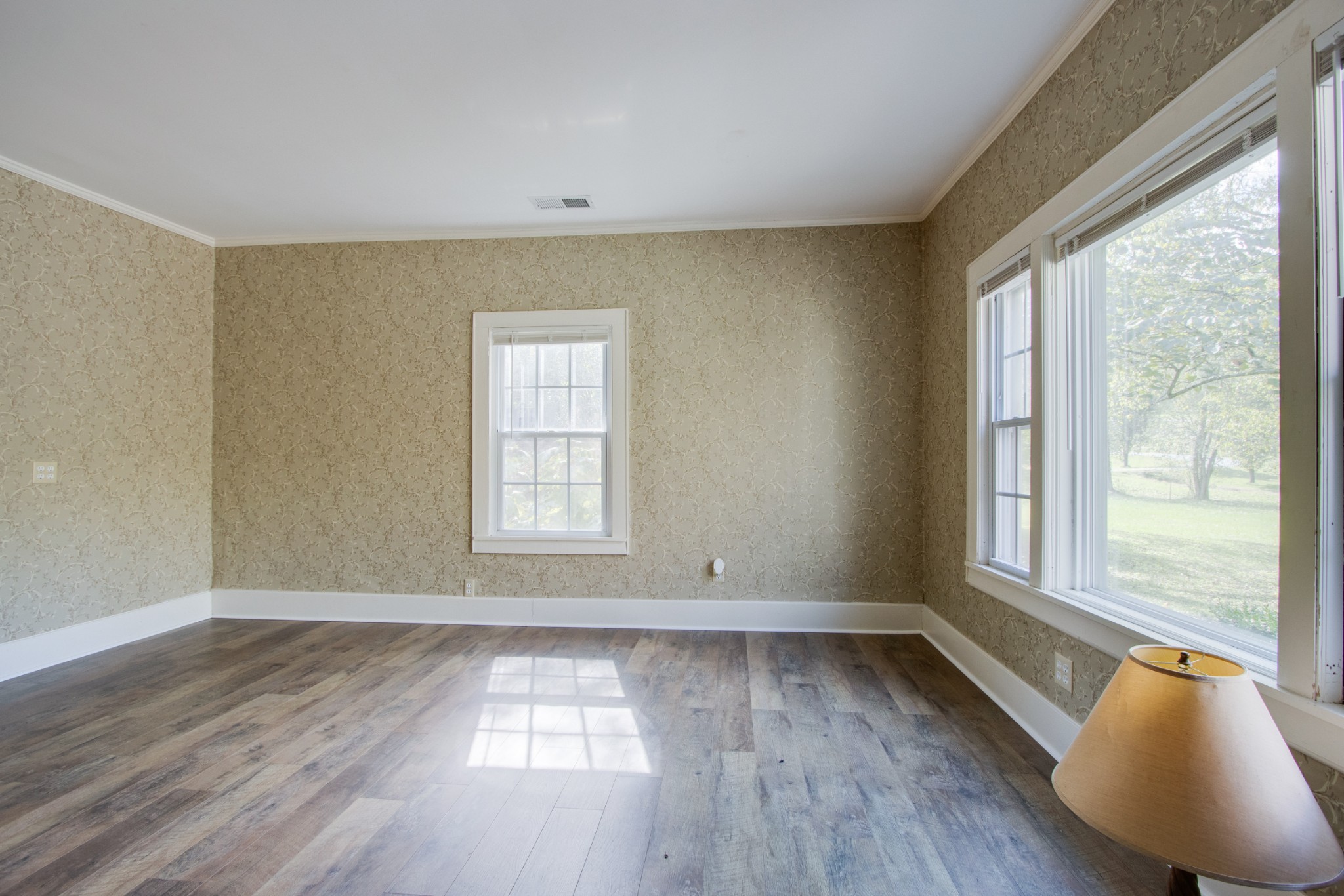 274 Hiwassee Road Lebanon, TN 37087 - Photo 5 of 44 an empty room with wooden floor and windows
