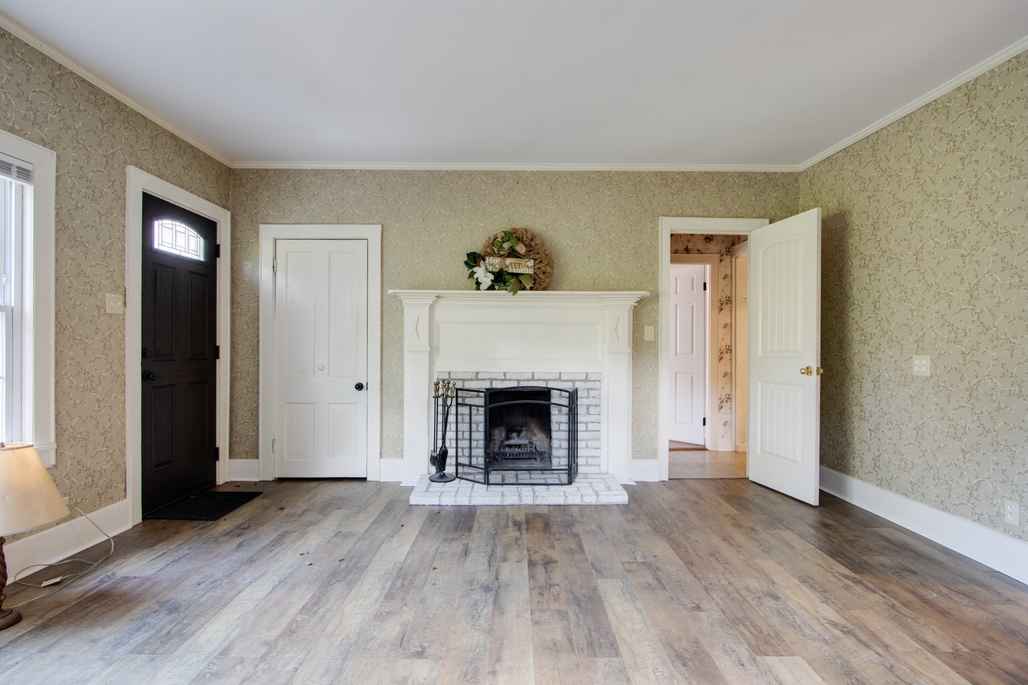 274 Hiwassee Road Lebanon, TN 37087 - Photo 6 of 44 an empty room with wooden floor fireplace and windows