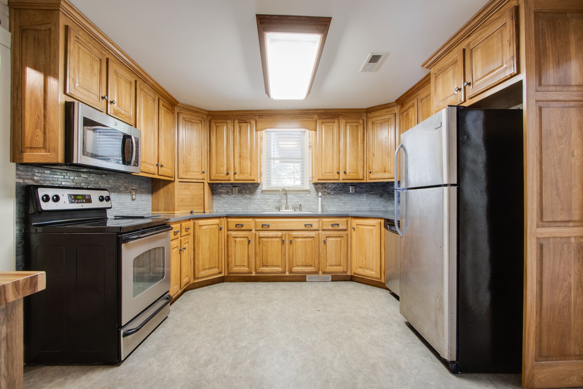274 Hiwassee Road Lebanon, TN 37087 - Photo 10 of 44 a kitchen with stainless steel appliances granite countertop a refrigerator a stove a sink and a microwave oven