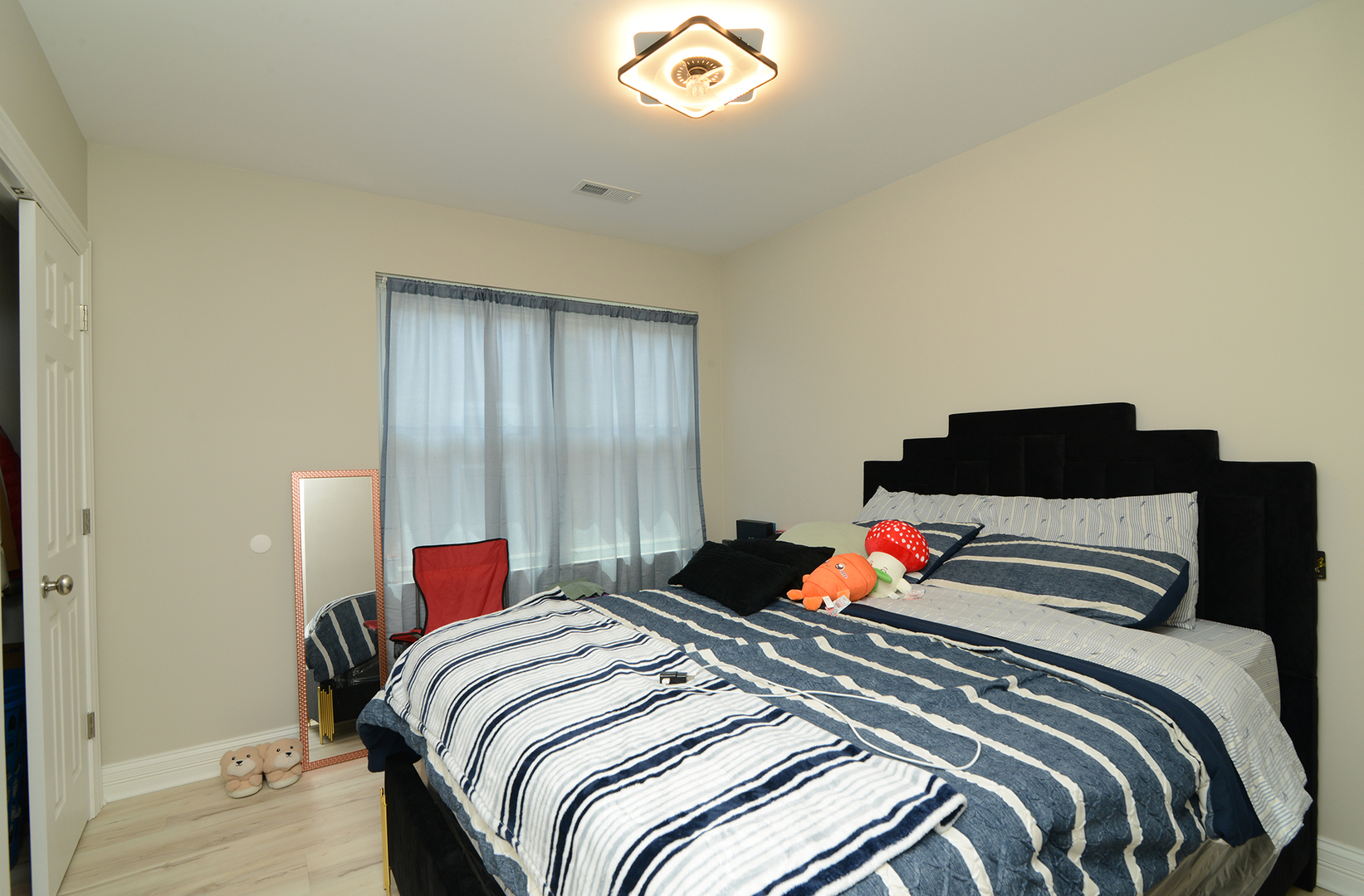 1051 North Springfield Avenue Chicago, IL 60651 - Photo 47 of 50 a bedroom with a bed and a lamp