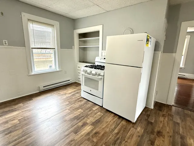 a white refrigerator freezer sitting inside of a kitchen