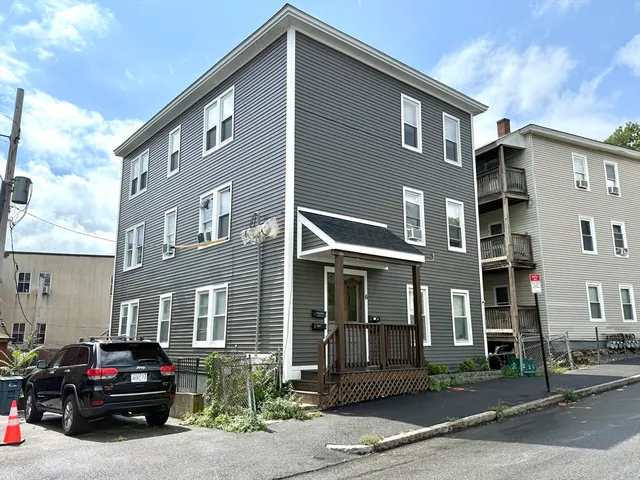a red car parked in front of a building