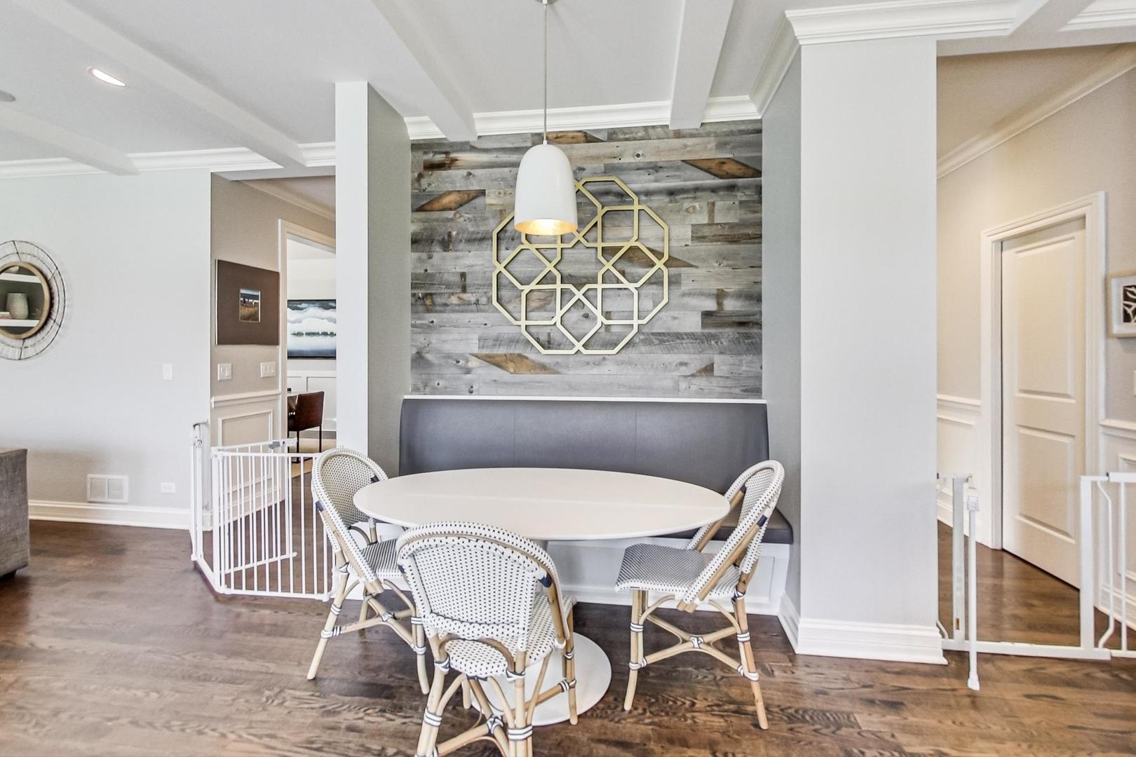 219 Clinton Avenue Elmhurst, IL 60126 - Photo 12 of 49 a view of a dining room with furniture and wooden floor
