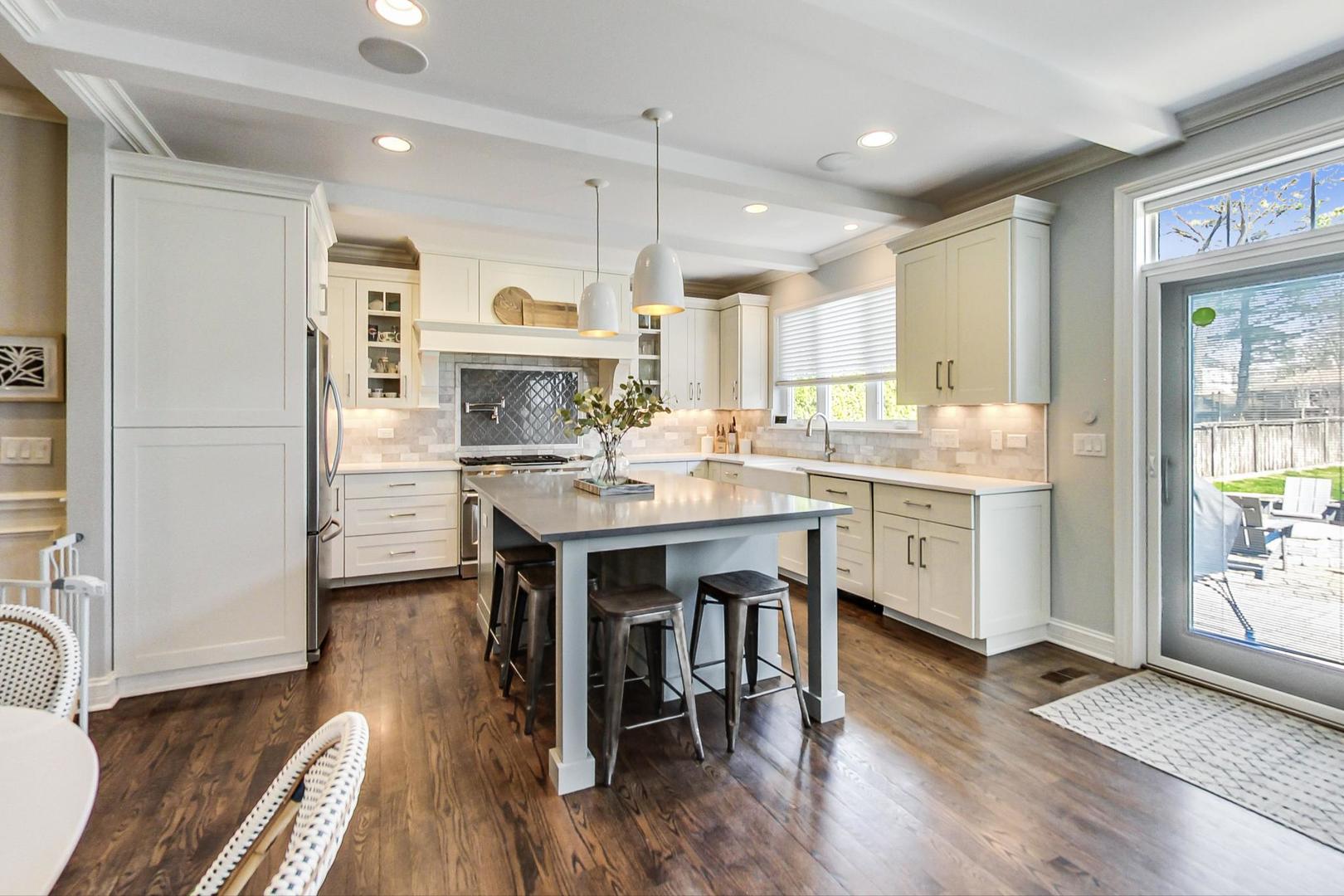 219 Clinton Avenue Elmhurst, IL 60126 - Photo 13 of 49 a kitchen with a table chairs refrigerator and microwave