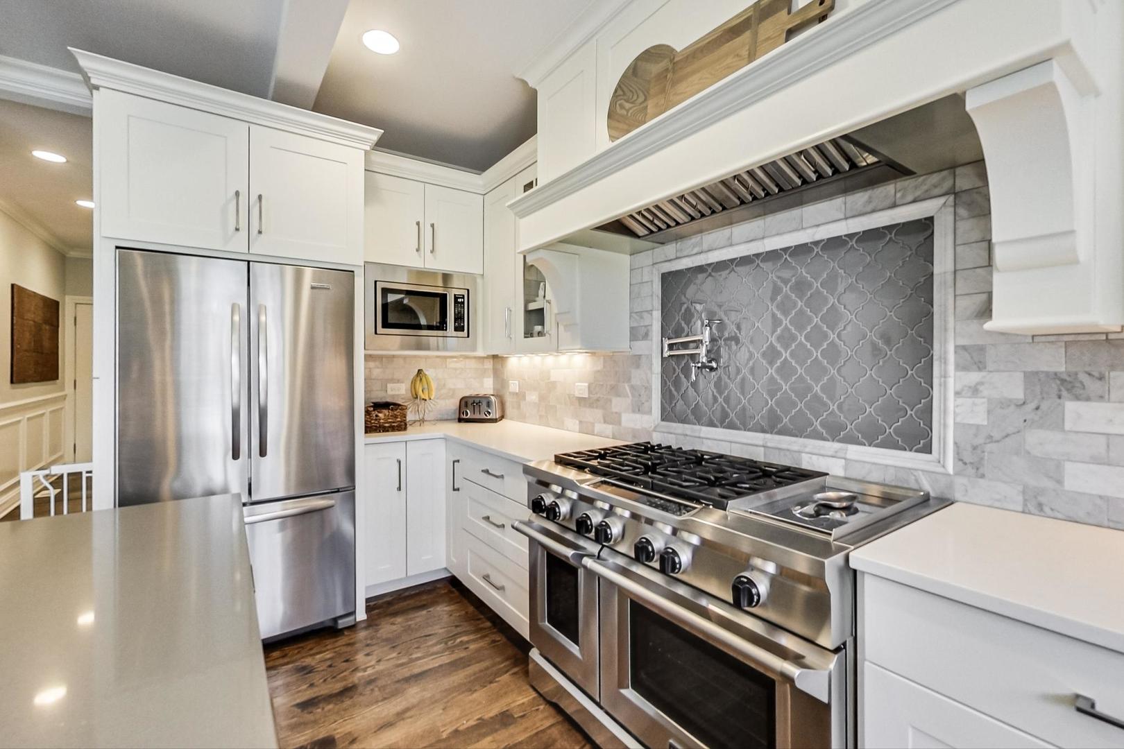 219 Clinton Avenue Elmhurst, IL 60126 - Photo 15 of 49 a kitchen with granite countertop a stove and a refrigerator