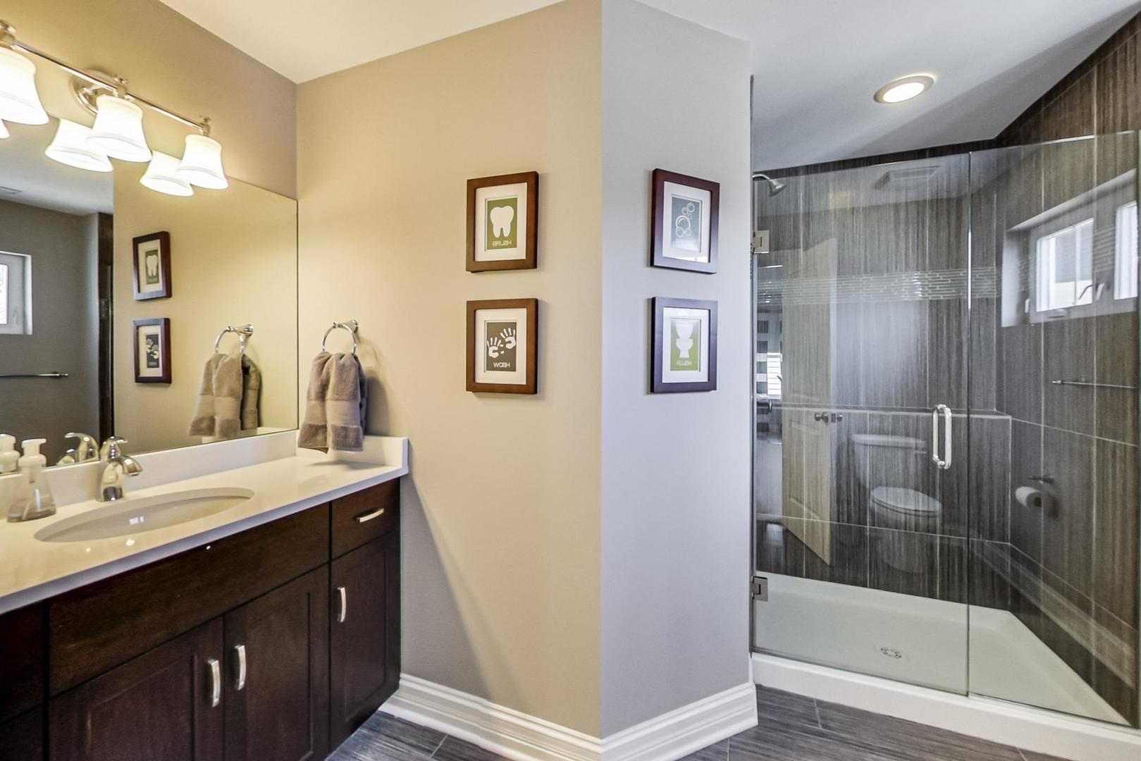 219 Clinton Avenue Elmhurst, IL 60126 - Photo 26 of 49 a bathroom with a shower sink and mirror