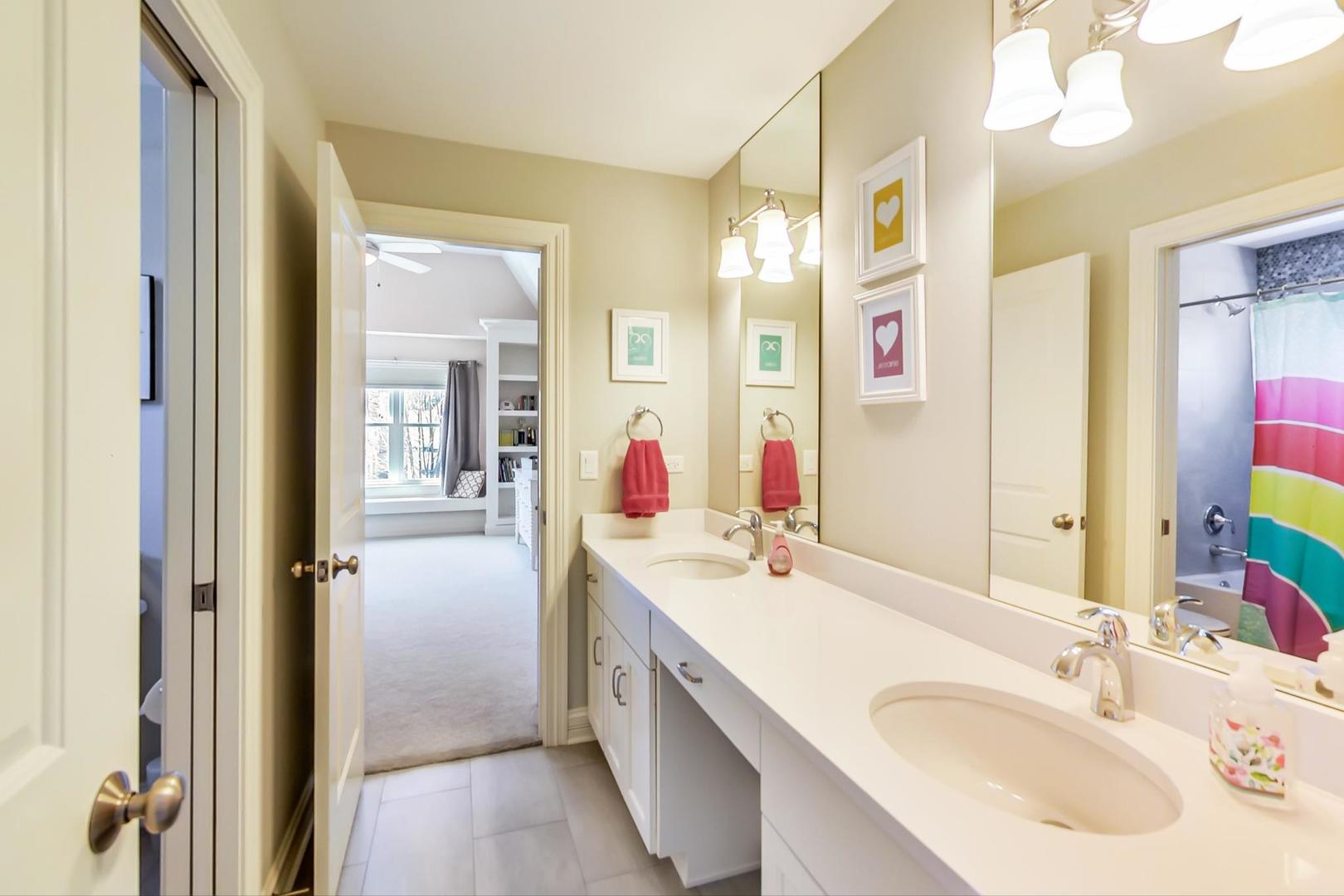 219 Clinton Avenue Elmhurst, IL 60126 - Photo 29 of 49 a en suite bathroom with a sink vanity granite and a mirror