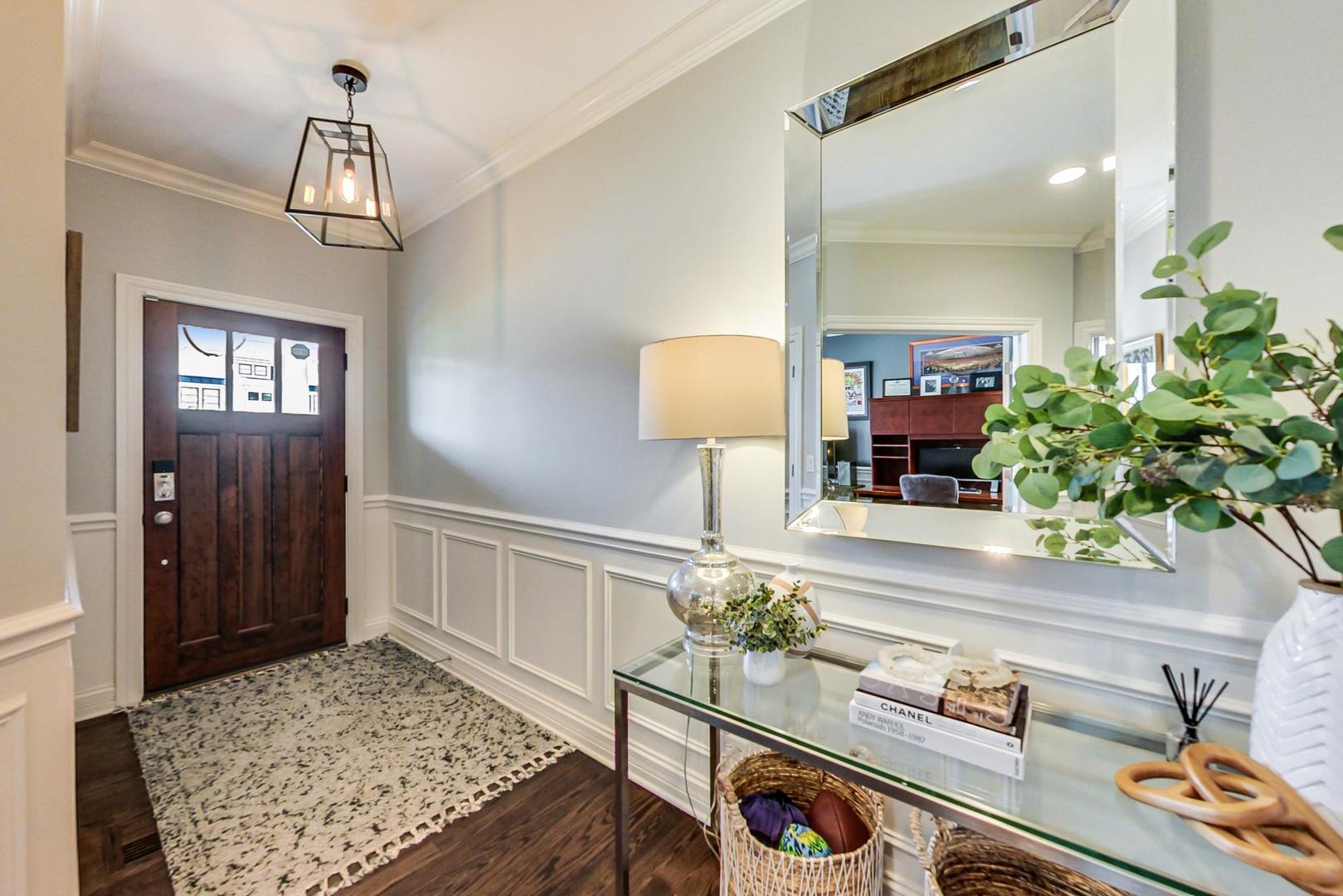 219 Clinton Avenue Elmhurst, IL 60126 - Photo 3 of 49 a living room with furniture and a chandelier