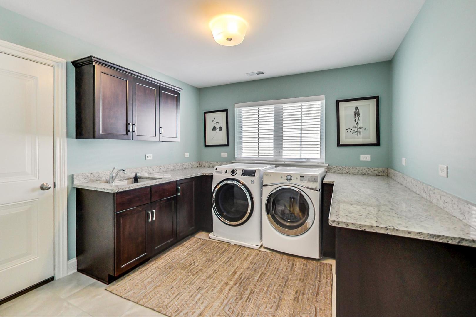 219 Clinton Avenue Elmhurst, IL 60126 - Photo 31 of 49 a bathroom with a granite countertop double vanity and a mirror