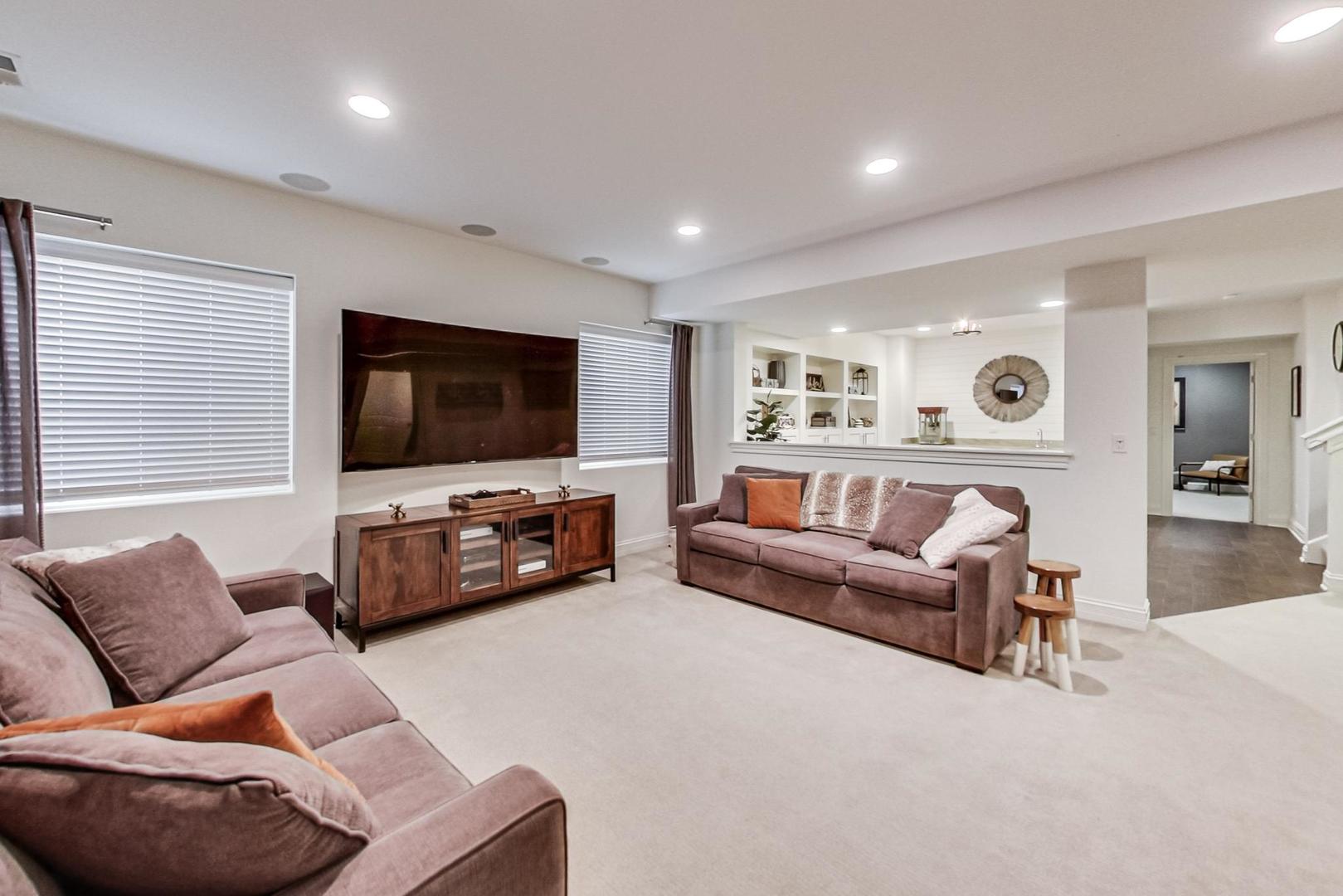 219 Clinton Avenue Elmhurst, IL 60126 - Photo 32 of 49 a living room with furniture and a flat screen tv