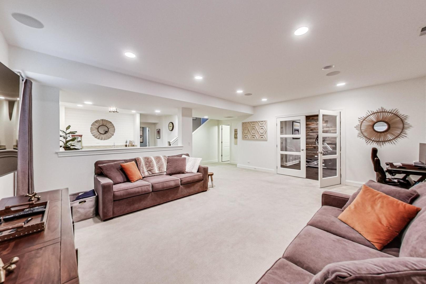 219 Clinton Avenue Elmhurst, IL 60126 - Photo 34 of 49 a living room with furniture and a flat screen tv