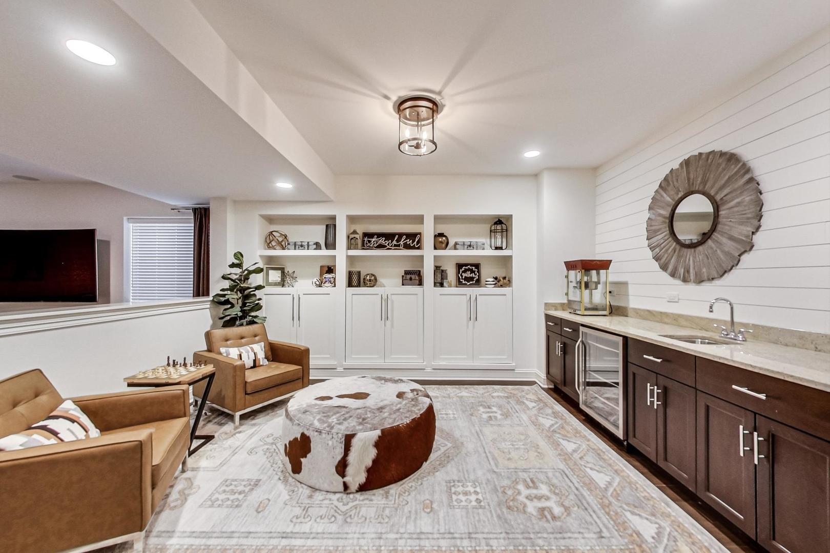 219 Clinton Avenue Elmhurst, IL 60126 - Photo 35 of 49 a living room with furniture and a flat screen tv