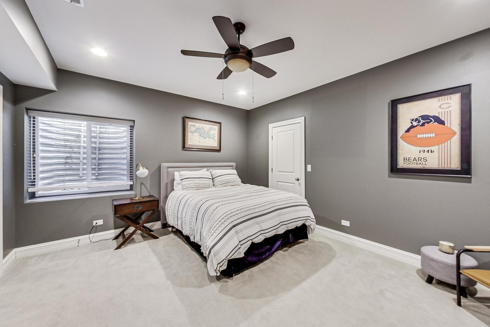 219 Clinton Avenue Elmhurst, IL 60126 - Photo 38 of 49 a bedroom with a bed and a chandelier