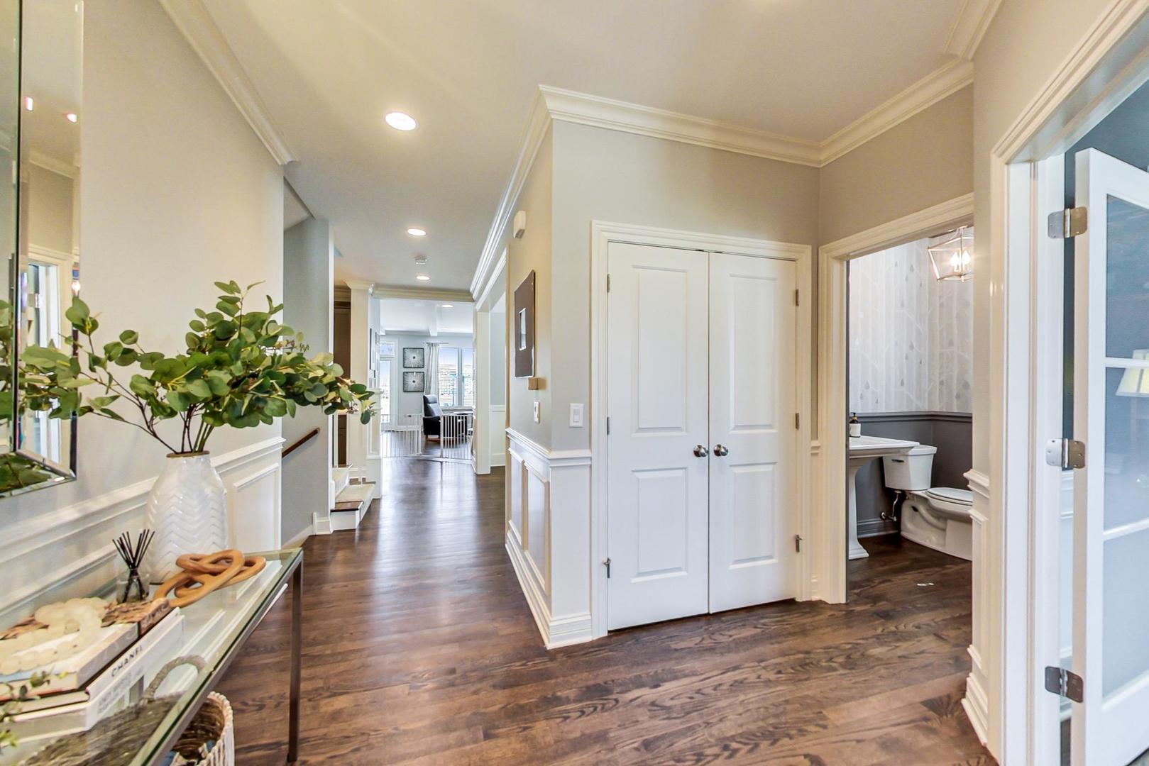 219 Clinton Avenue Elmhurst, IL 60126 - Photo 4 of 49 a view of a hallway with wooden floor and furniture