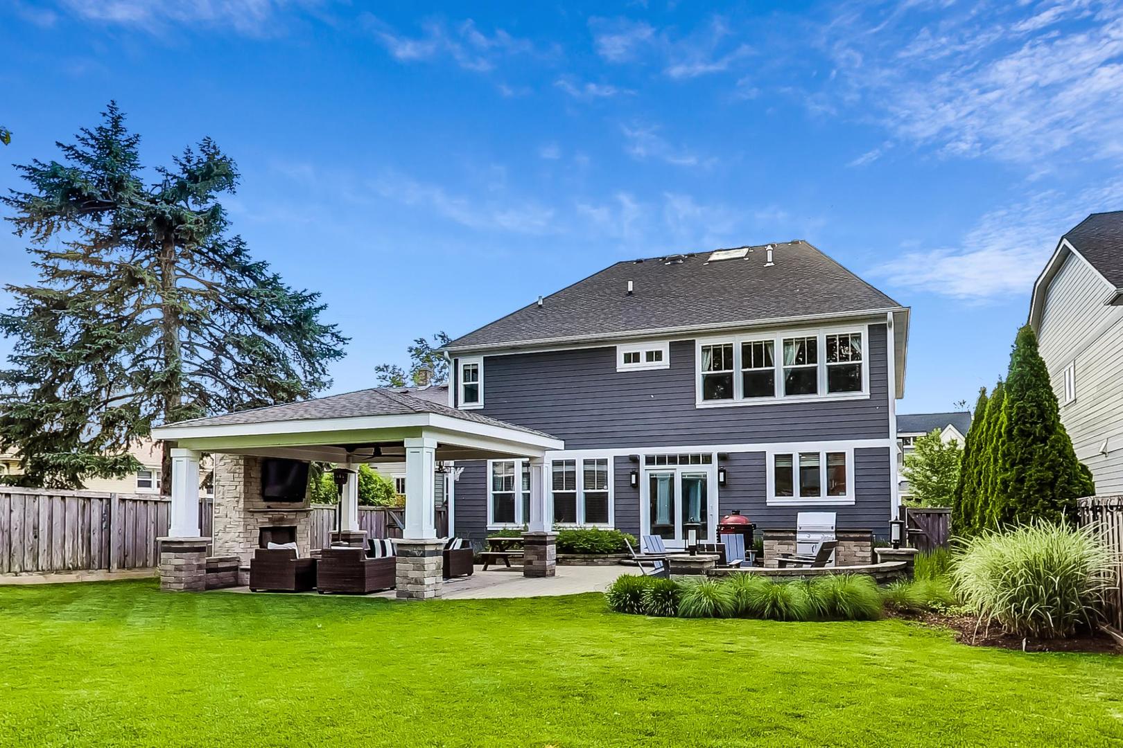 219 Clinton Avenue Elmhurst, IL 60126 - Photo 41 of 49 a front view of a house with a garden and swimming pool