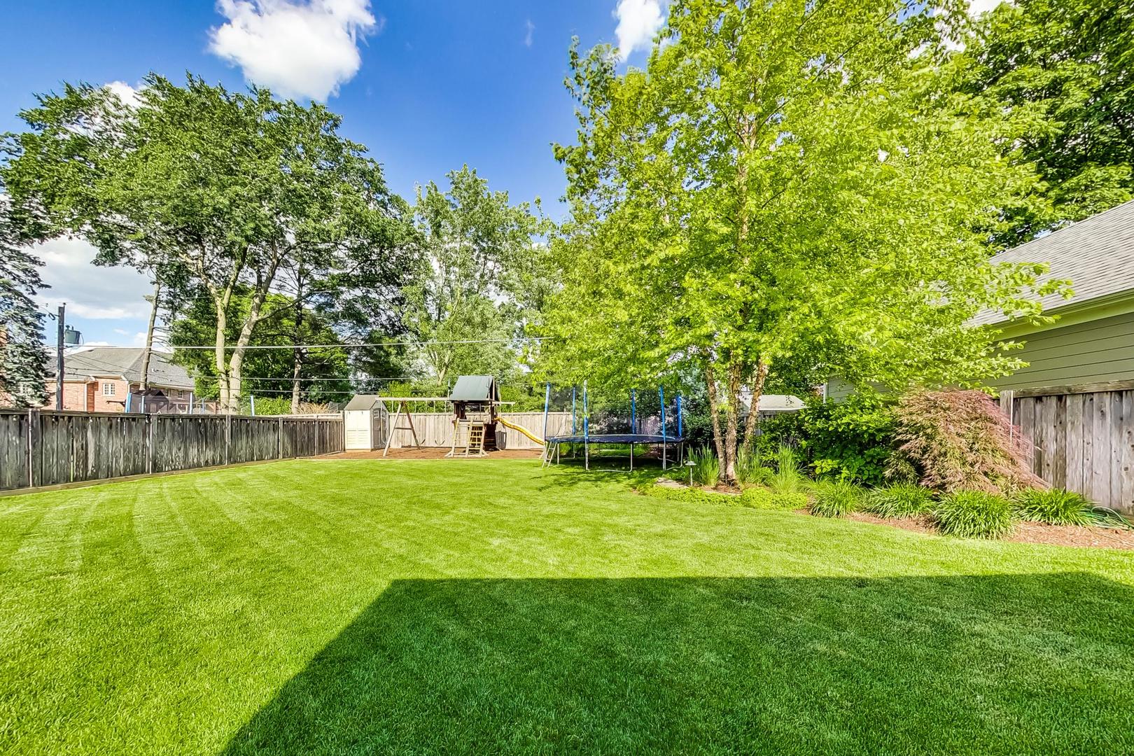 219 Clinton Avenue Elmhurst, IL 60126 - Photo 46 of 49 a backyard of a house with table and chairs