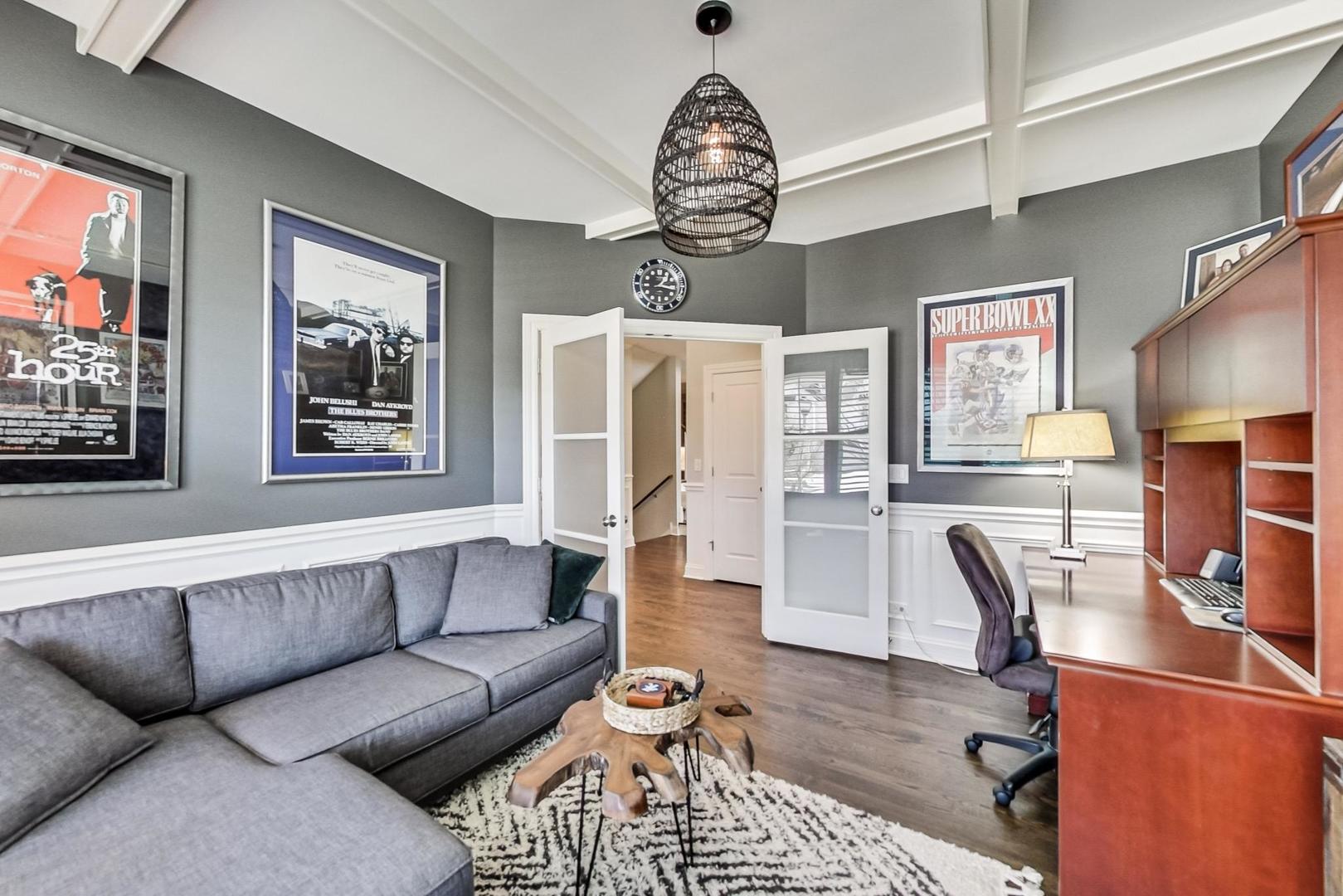 219 Clinton Avenue Elmhurst, IL 60126 - Photo 6 of 49 a living room with furniture a dining table and a chandelier