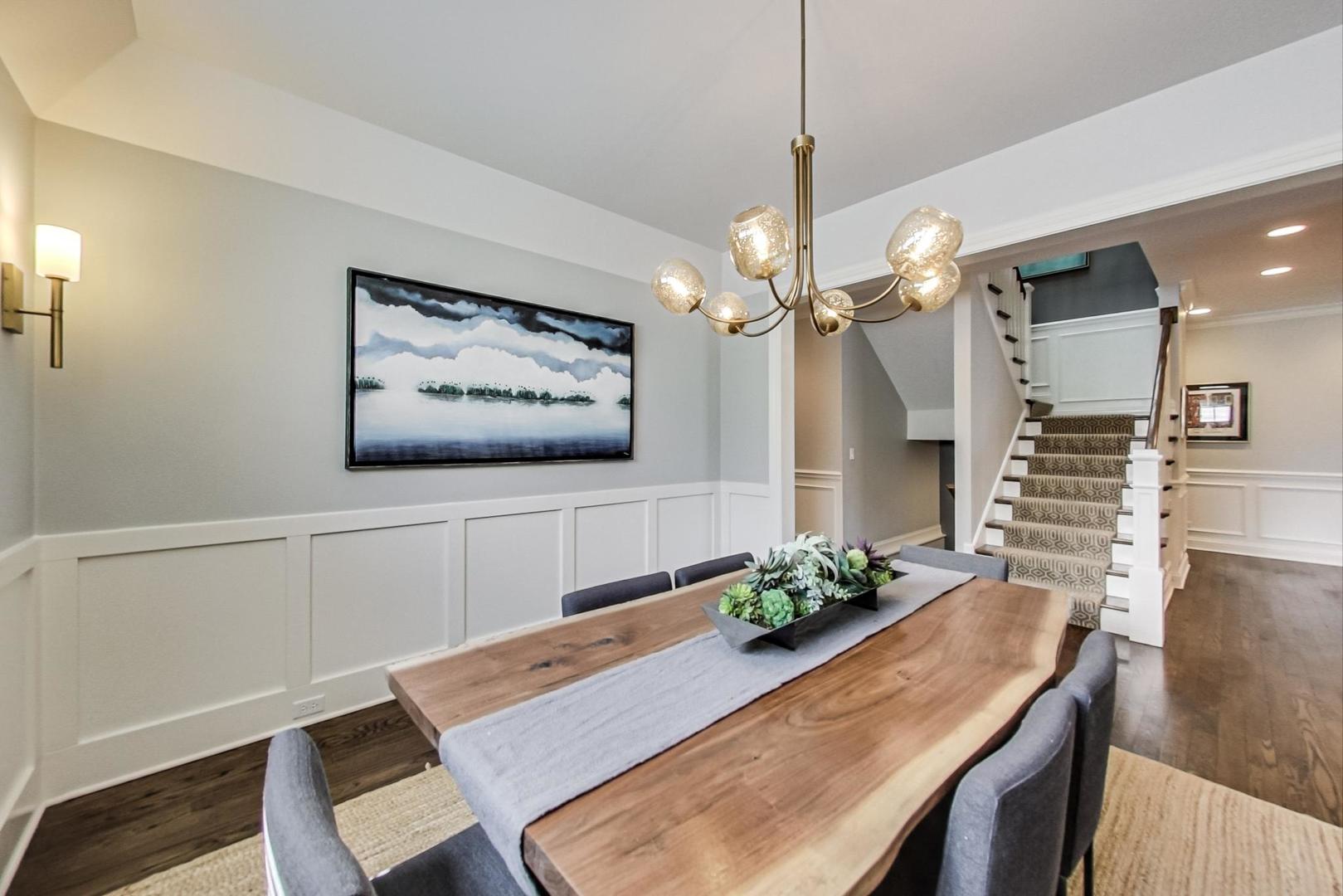 219 Clinton Avenue Elmhurst, IL 60126 - Photo 8 of 49 a view of a dining room with furniture and wooden floor