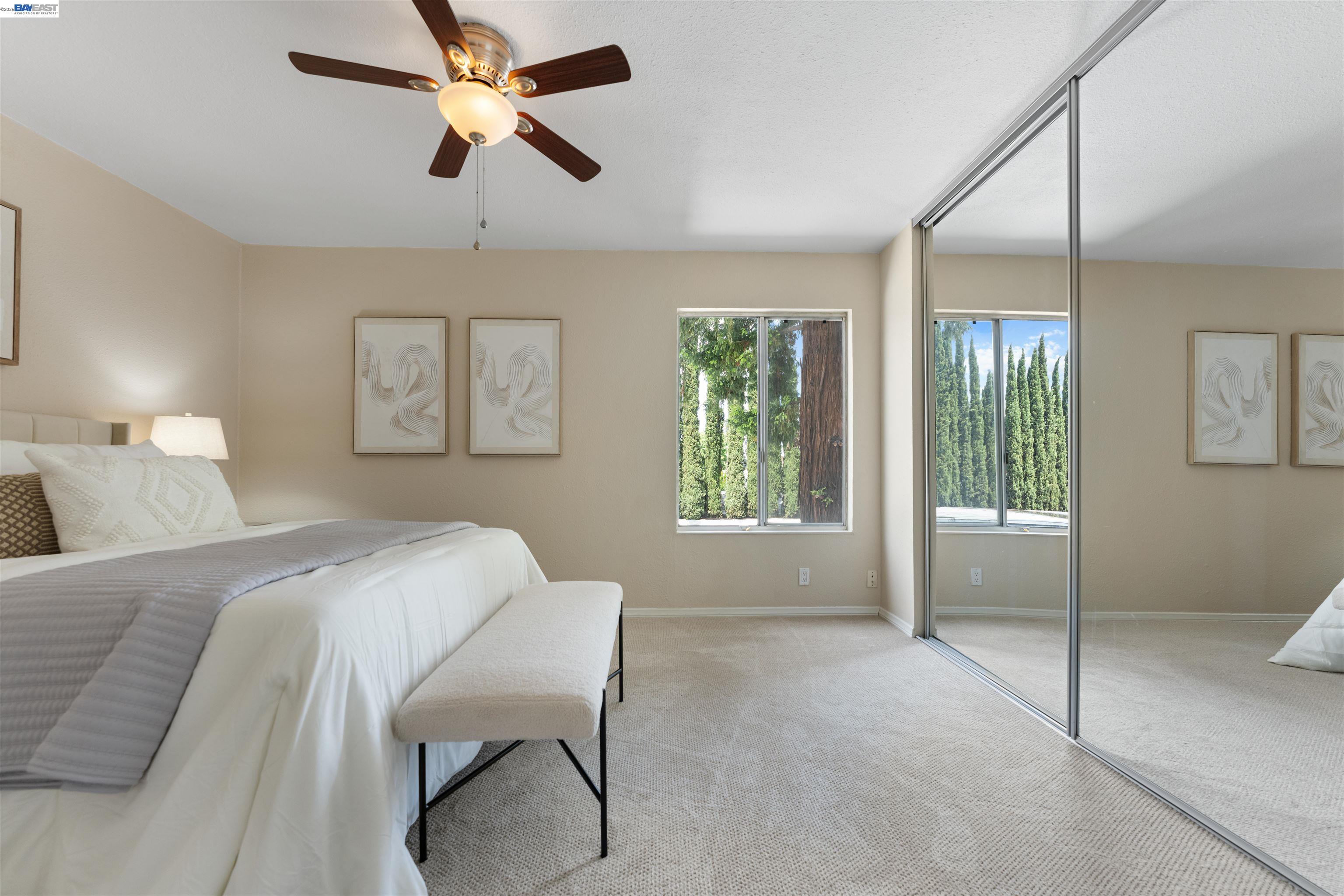 4081 Clayton Road, Unit 221 Concord, CA 94521 - Photo 15 of 23 a bedroom with a bed and a chandelier