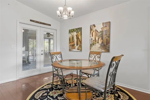 a view of a dining room with furniture and chandelier