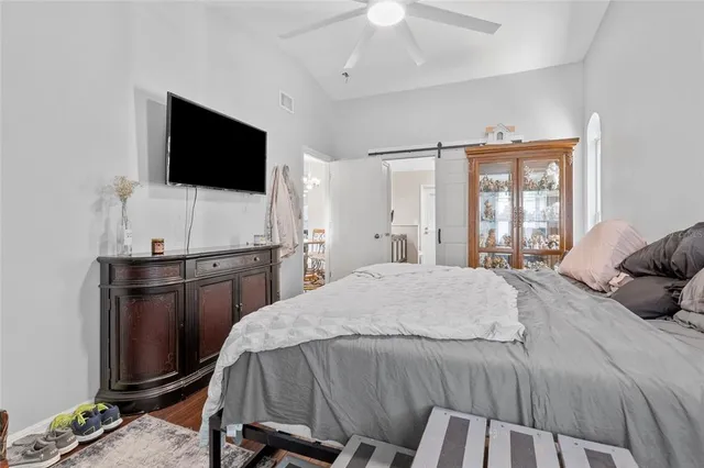 a bedroom with a bed and a flat screen tv