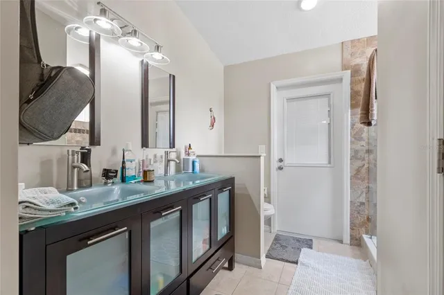 a bathroom with a double vanity sink and a mirror