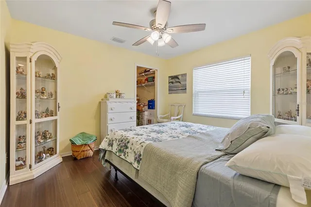 a bedroom with a large bed and a chandelier