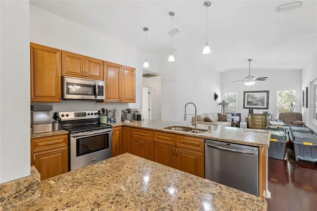 a kitchen with stainless steel appliances granite countertop a stove sink and cabinets