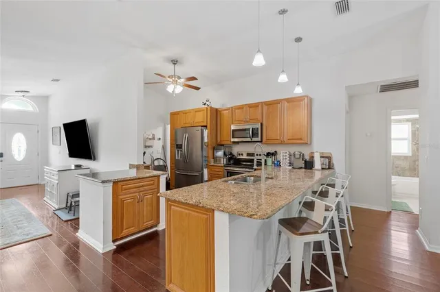 a view of kitchen with cabinets stainless steel appliances with wooden floor