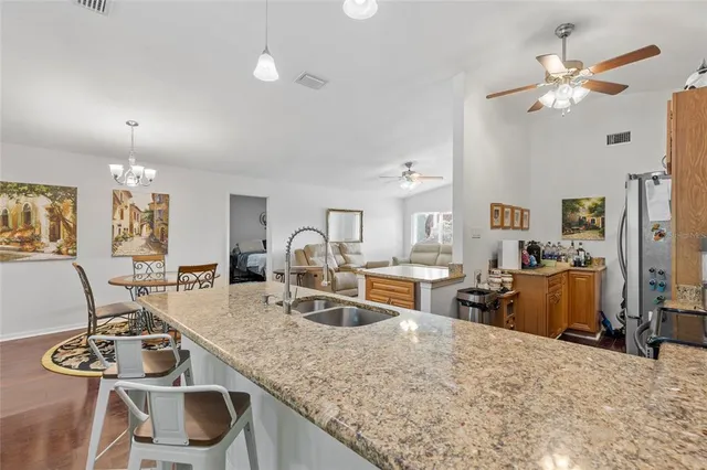 a kitchen with sink refrigerator and stove