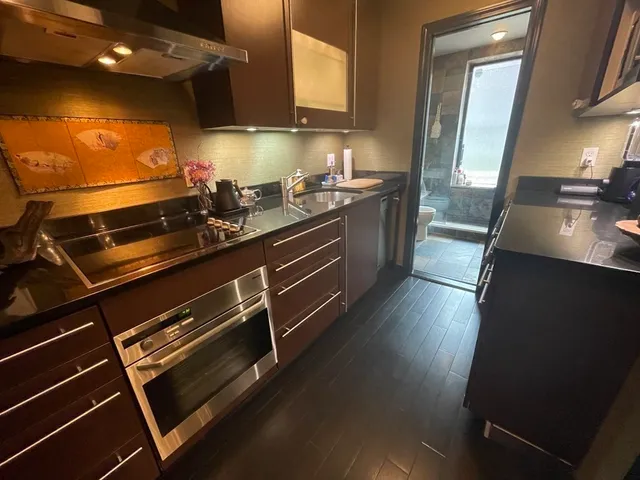 a kitchen with sink microwave and stove
