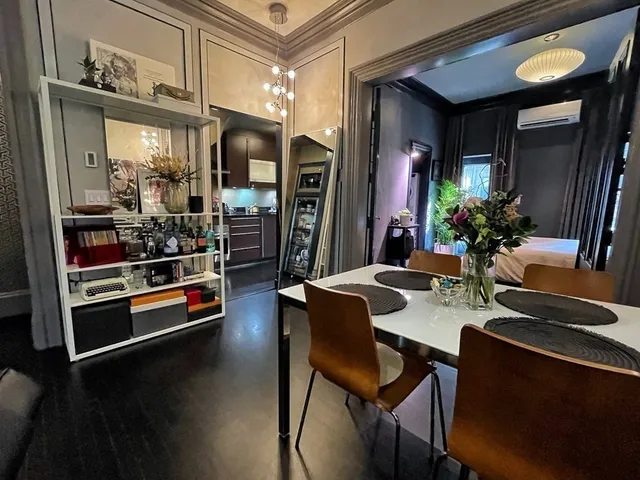 a dining room with furniture and chandelier