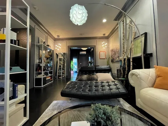 a living room with furniture and a chandelier