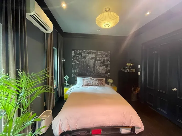 a bedroom with a bed and a potted plant