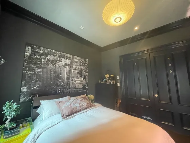 a bedroom with a bed and a chandelier
