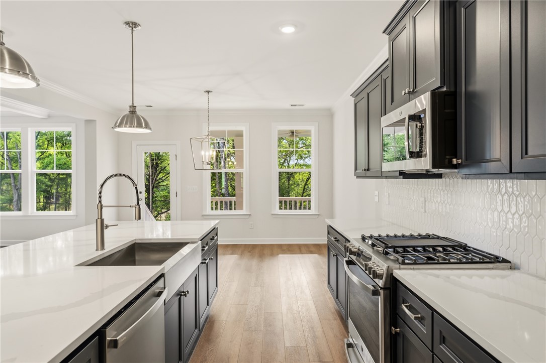 1108 Manse Jolly Road Anderson, SC 29621 - Photo 11 of 45 This spacious kitchen offers a blend of modern design and natural light, perfect for culinary endeavors.