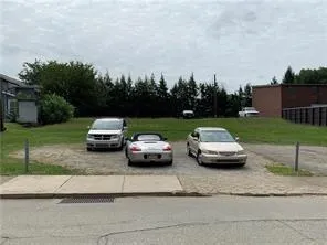 a couple of cars parked in front of a yard