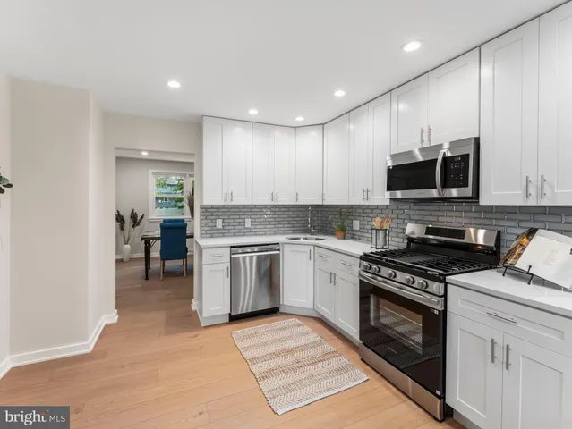 a kitchen with a stove a sink and a microwave