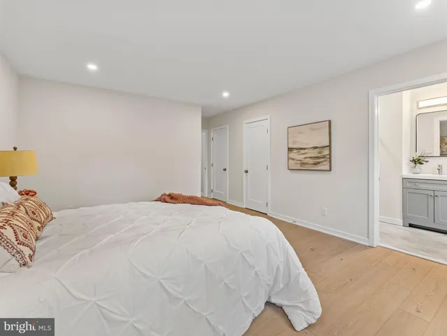 a bedroom with a bed and painting on the wall