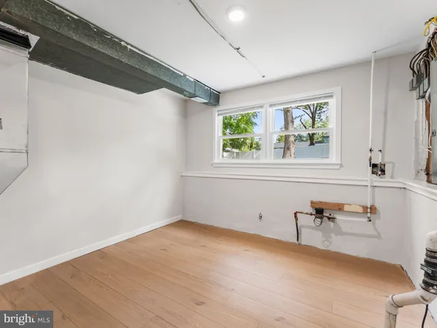 a view of a room with wooden floor and furniture