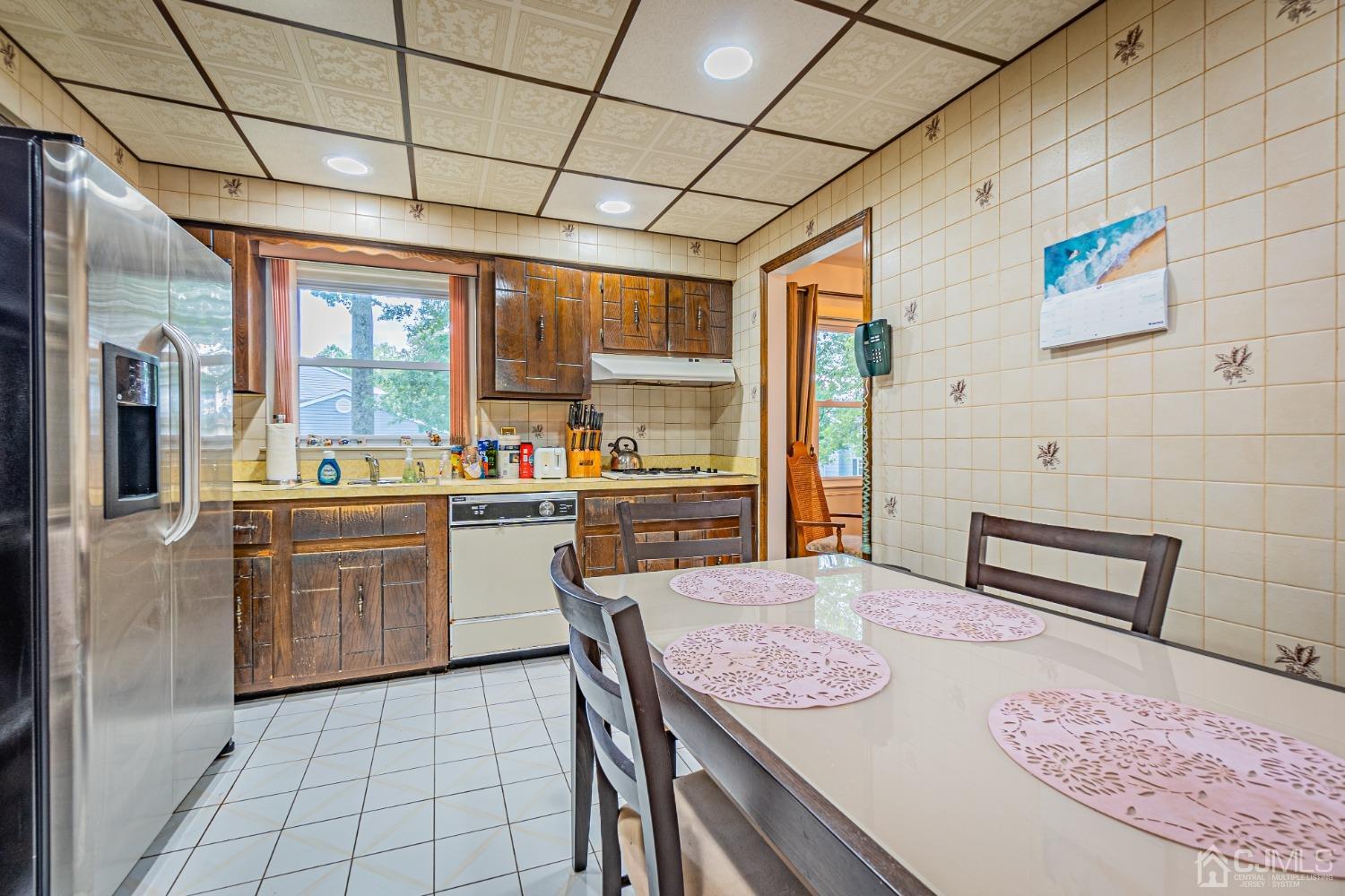 7 Meredith Road Edison, NJ 08817 - Photo 12 of 35 a kitchen with a sink a stove top oven a dining table and chairs