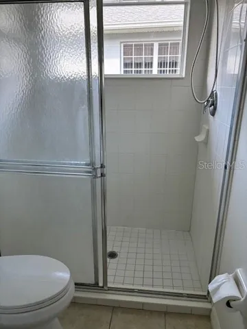 a bathroom with a toilet and a shower